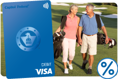 Older couple playing golf with a True Blue® debit card featured.